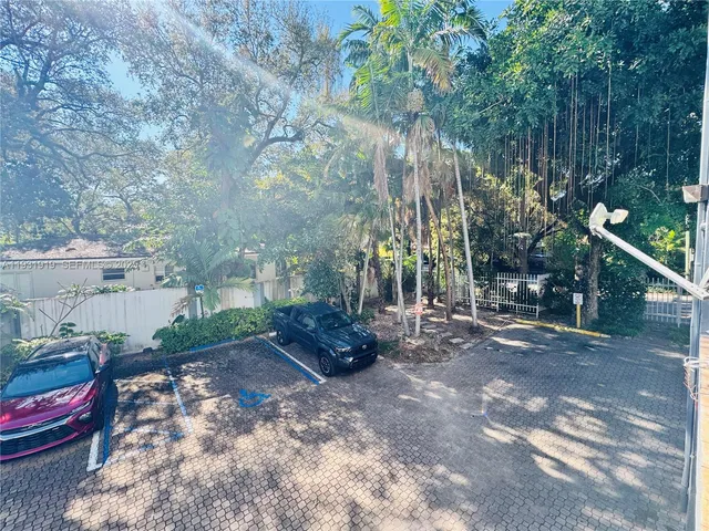 a view of a yard with potted plants