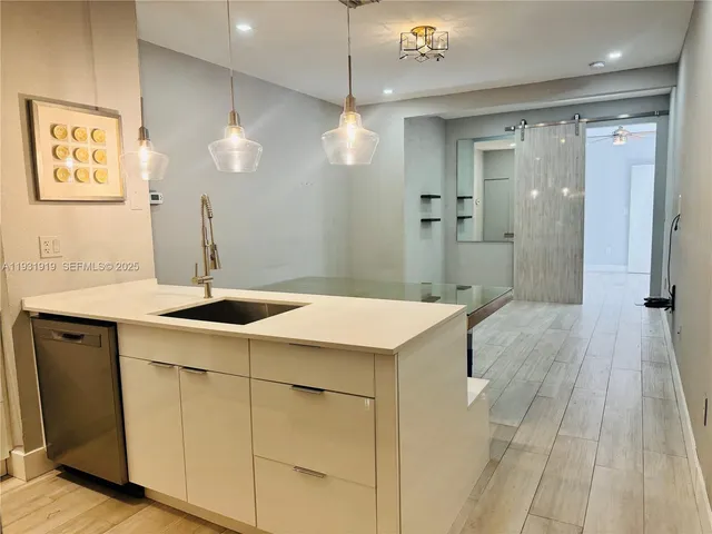 a kitchen with a sink and chandelier