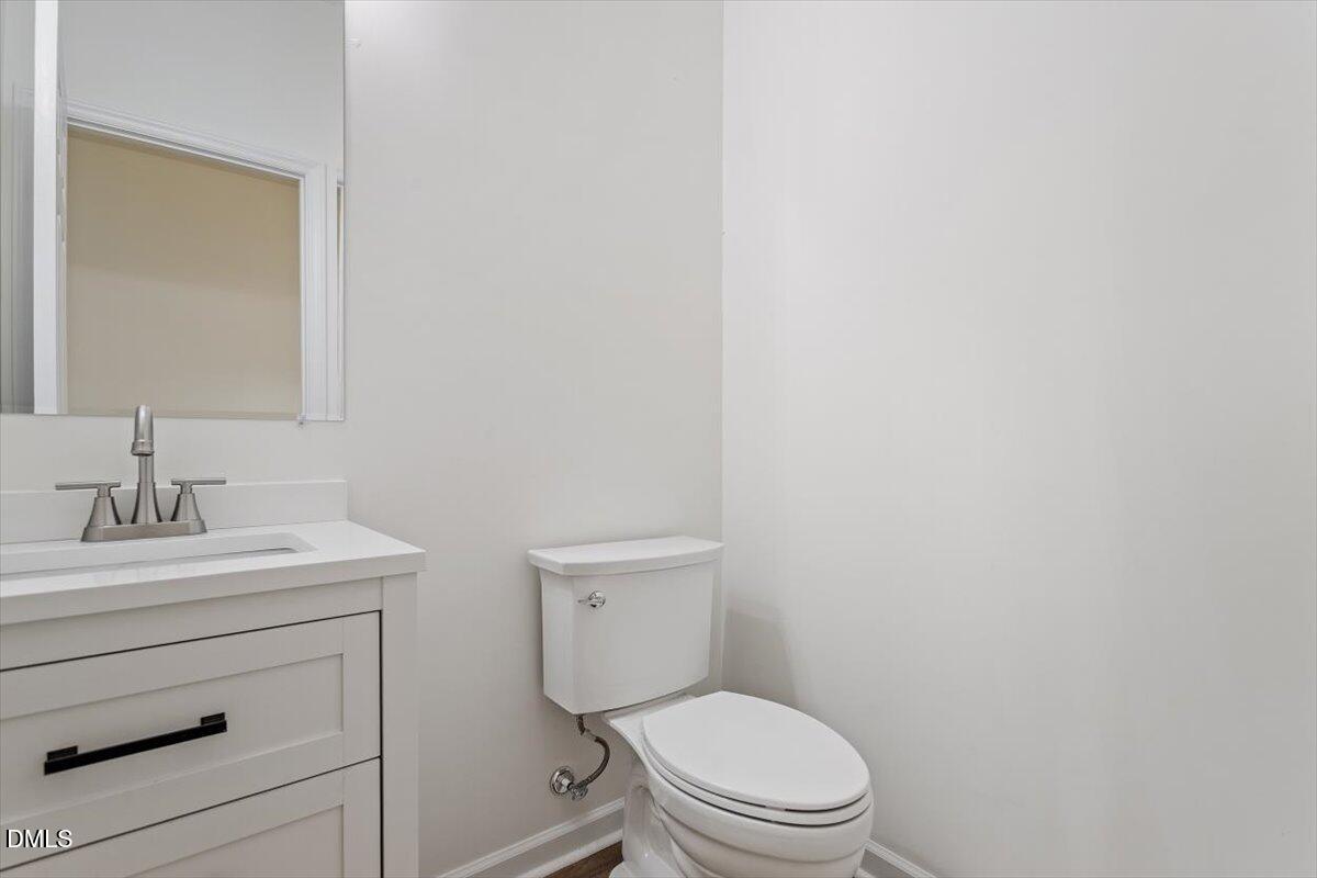 1408 South Street Durham, NC 27707 - Photo 11 of 37 a bathroom with a toilet a sink and mirror