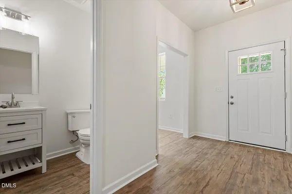 a view of bathroom with toilet vanity and a window