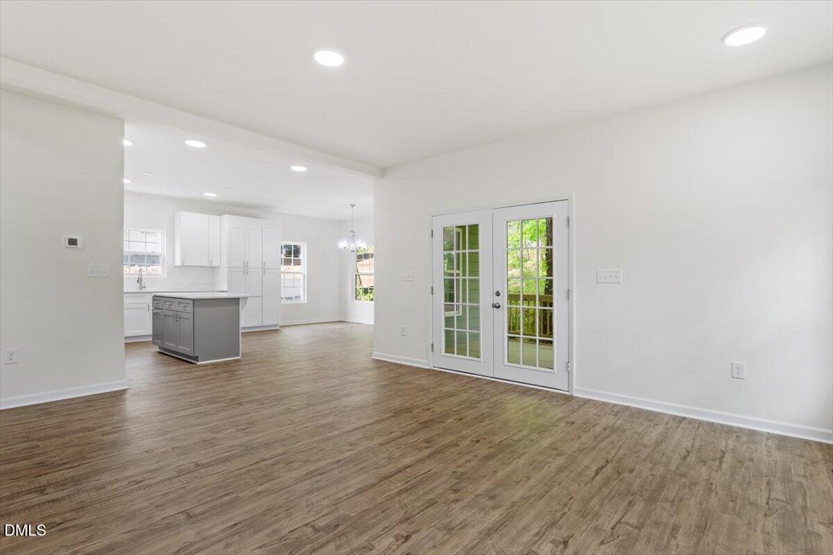 1408 South Street Durham, NC 27707 - Photo 14 of 37 a view of an empty room with wooden floor and a window
