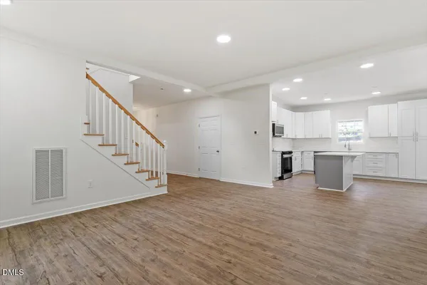 a view of kitchen with wooden floor and electronic appliances