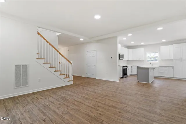 a view of kitchen with wooden floor and electronic appliances