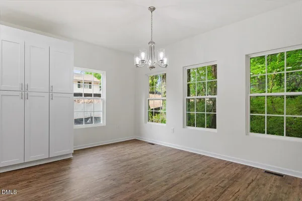 a view of livingroom with window wooden floor and front door