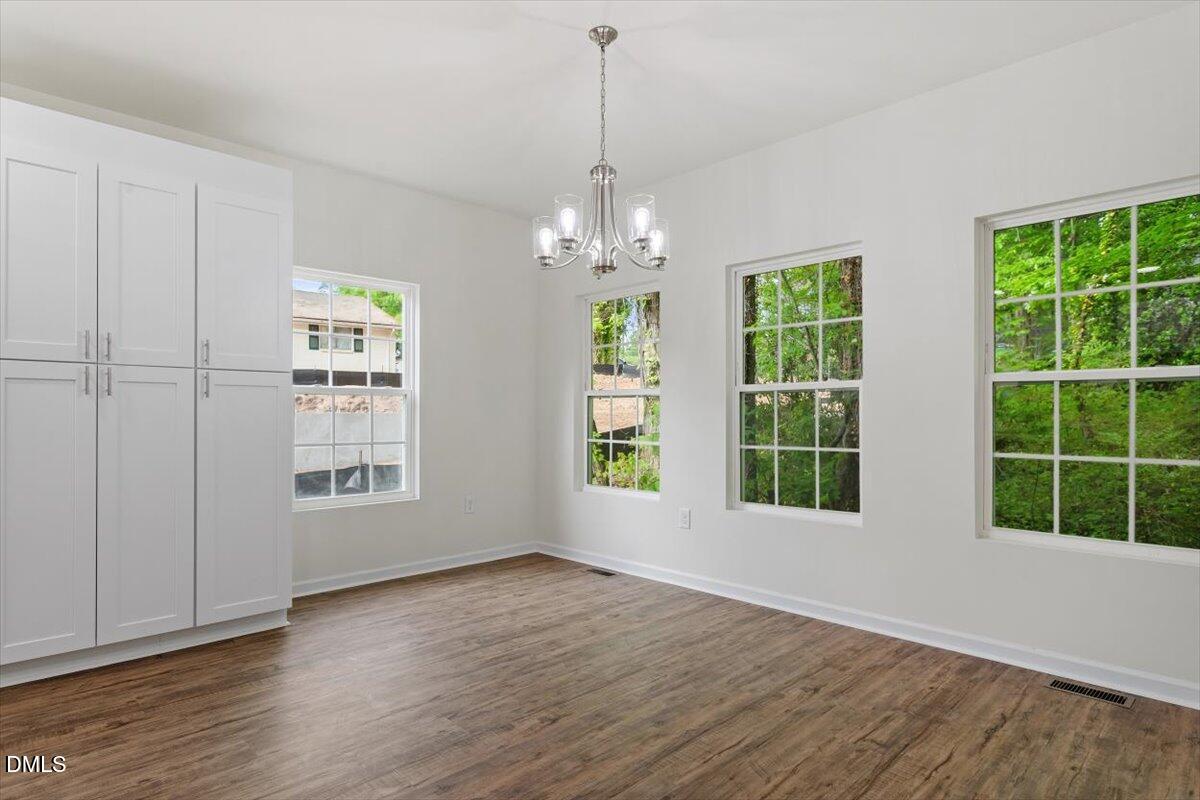 1408 South Street Durham, NC 27707 - Photo 19 of 37 a view of livingroom with window wooden floor and front door