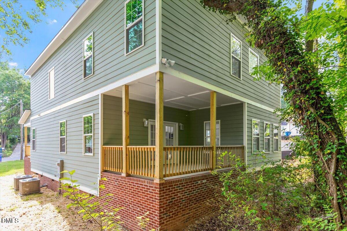 1408 South Street Durham, NC 27707 - Photo 2 of 37 a view of a house with a large window and wooden fence