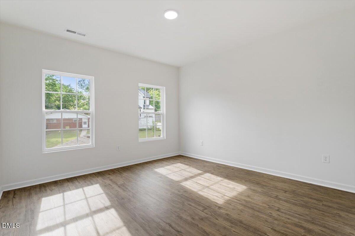 1408 South Street Durham, NC 27707 - Photo 27 of 37 an empty room with wooden floor and windows