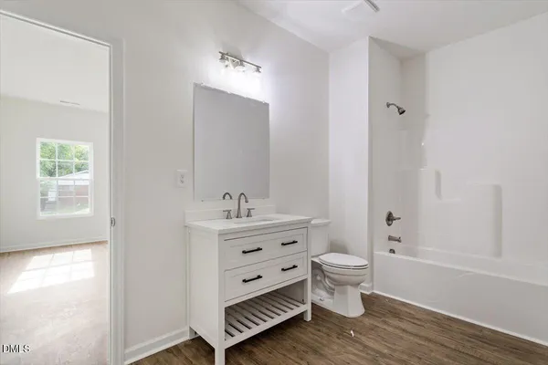 a view of bathroom with a toilet sink and mirror