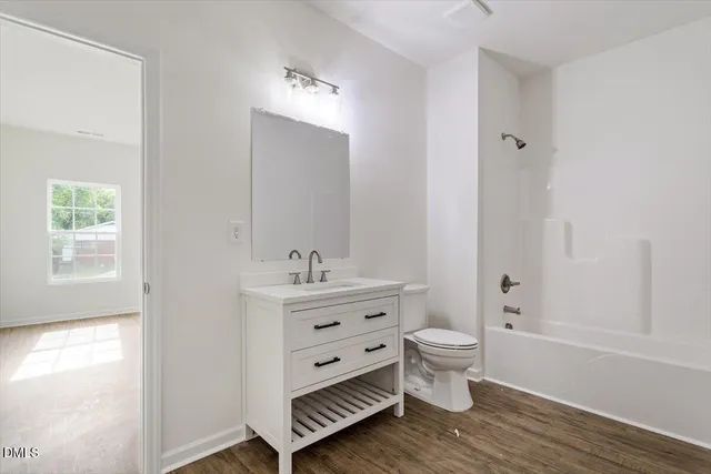 a view of bathroom with a toilet sink and mirror