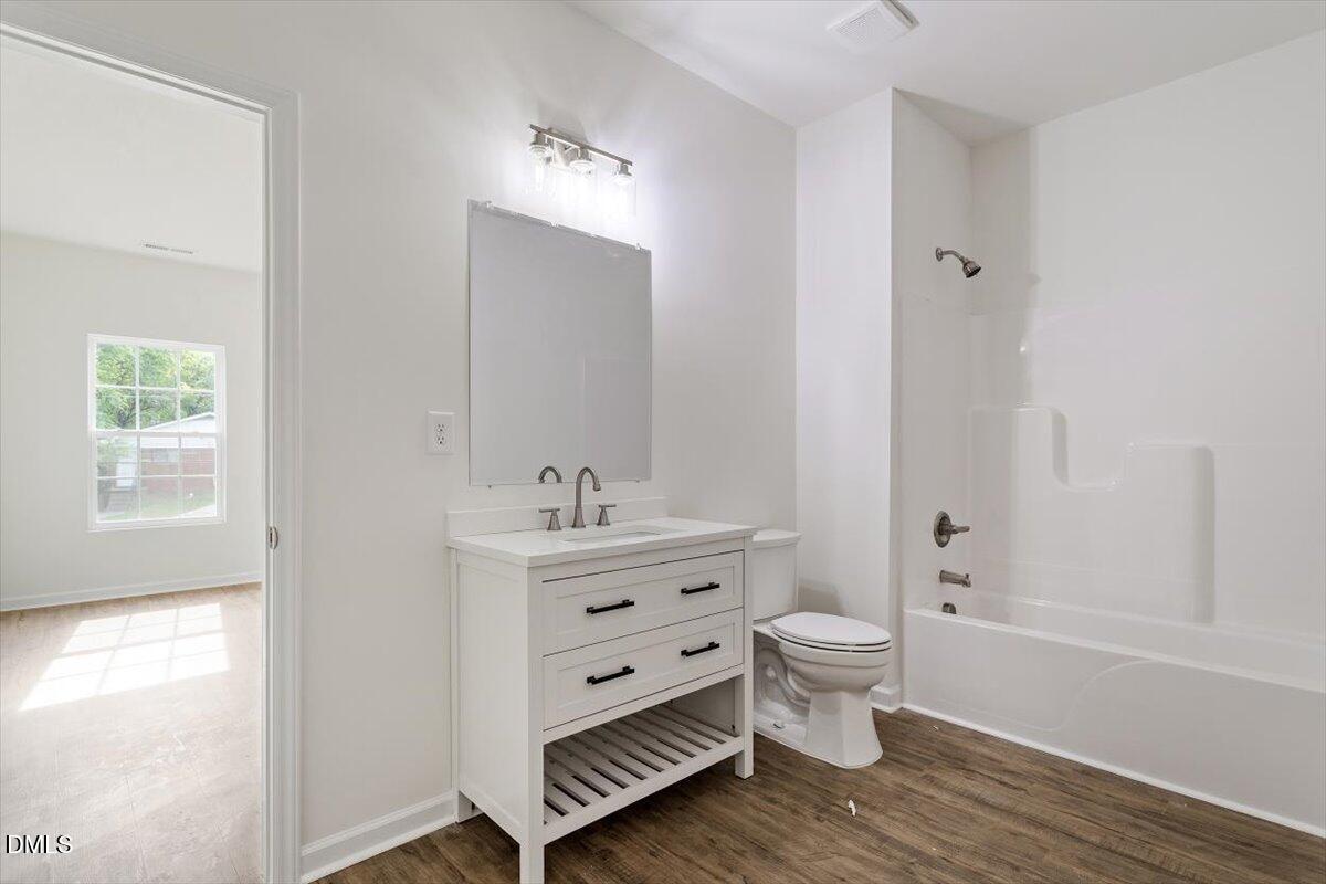 1408 South Street Durham, NC 27707 - Photo 29 of 37 a view of bathroom with a toilet sink and mirror