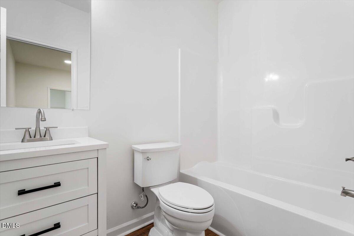 1408 South Street Durham, NC 27707 - Photo 32 of 37 a bathroom with a sink a toilet and a bathtub