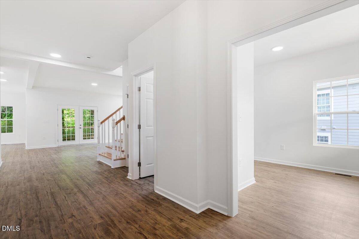 1408 South Street Durham, NC 27707 - Photo 9 of 37 an empty room with wooden floor and windows