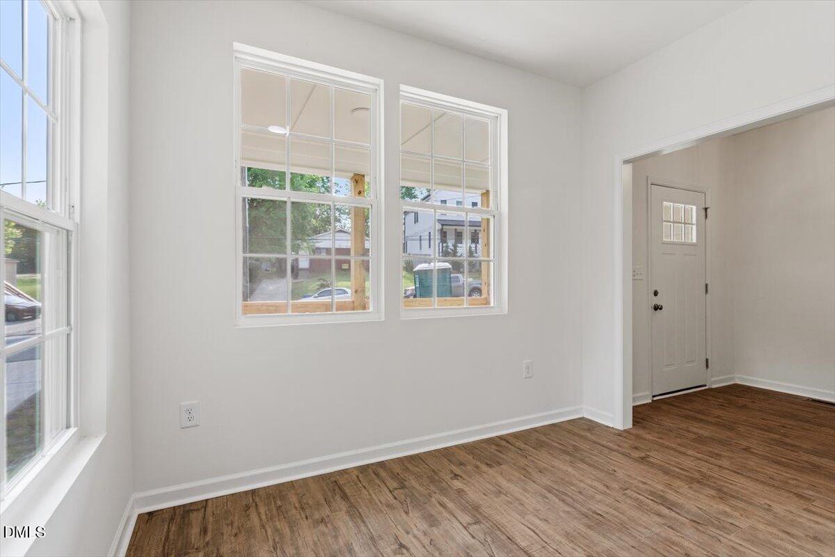 1408 South Street Durham, NC 27707 - Photo 10 of 37 a view of an empty room with wooden floor and a window