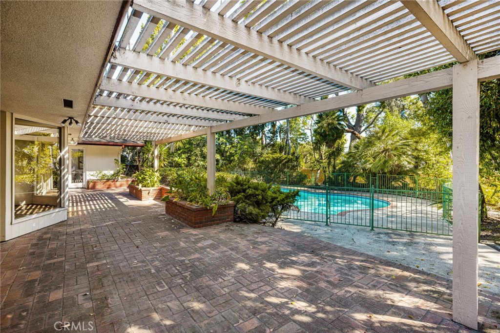 12011 Theta Road North Tustin, CA 92705 - Photo 12 of 49 A charming brick patio spans the length of the home. A portion (not shown) is fully covered for dining al fresco all year long.