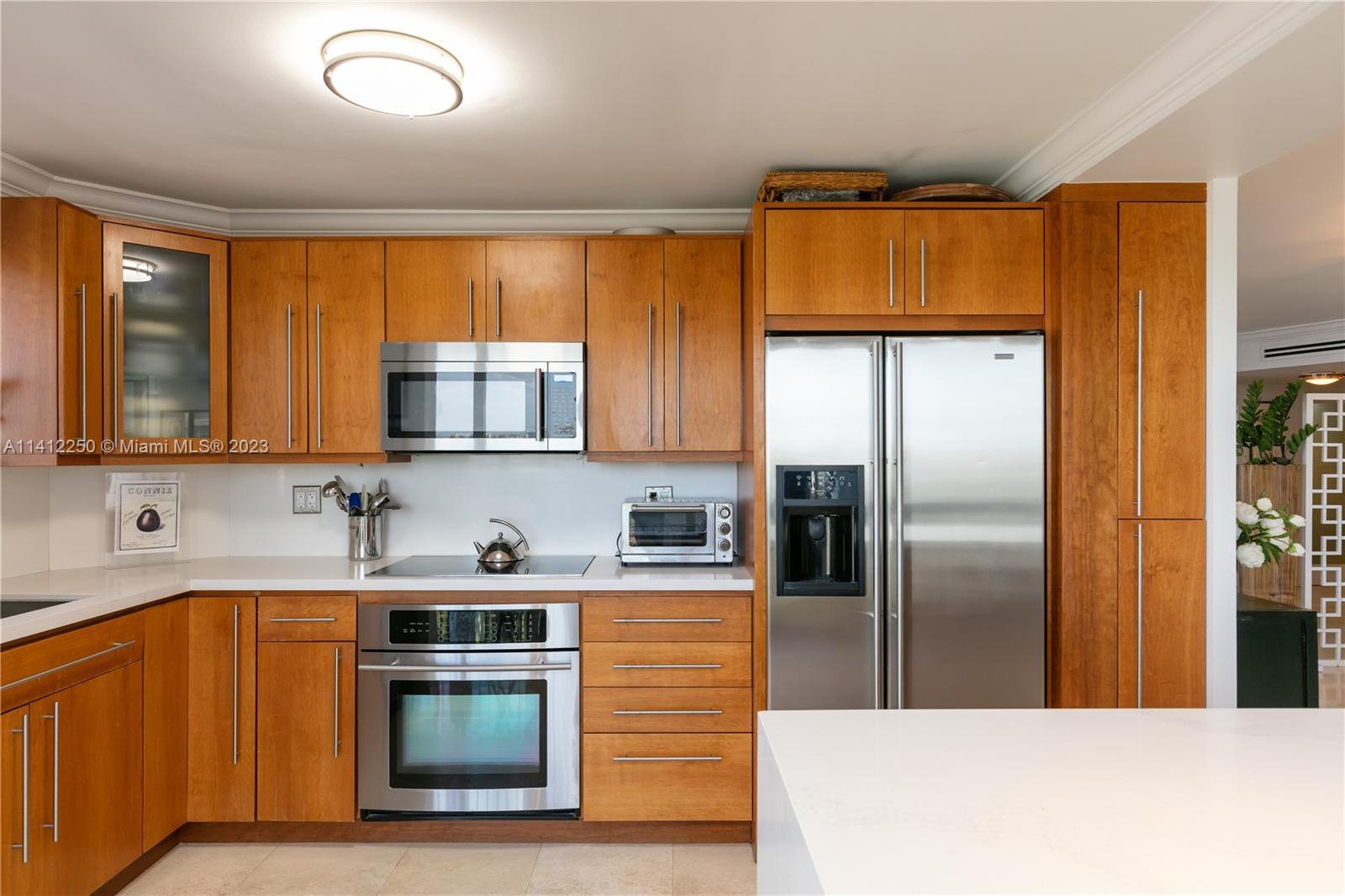 2333 Brickell Avenue, Unit 1511 Miami, FL 33129 - Photo 17 of 59 a kitchen with stainless steel appliances granite countertop a refrigerator a sink a stove and island