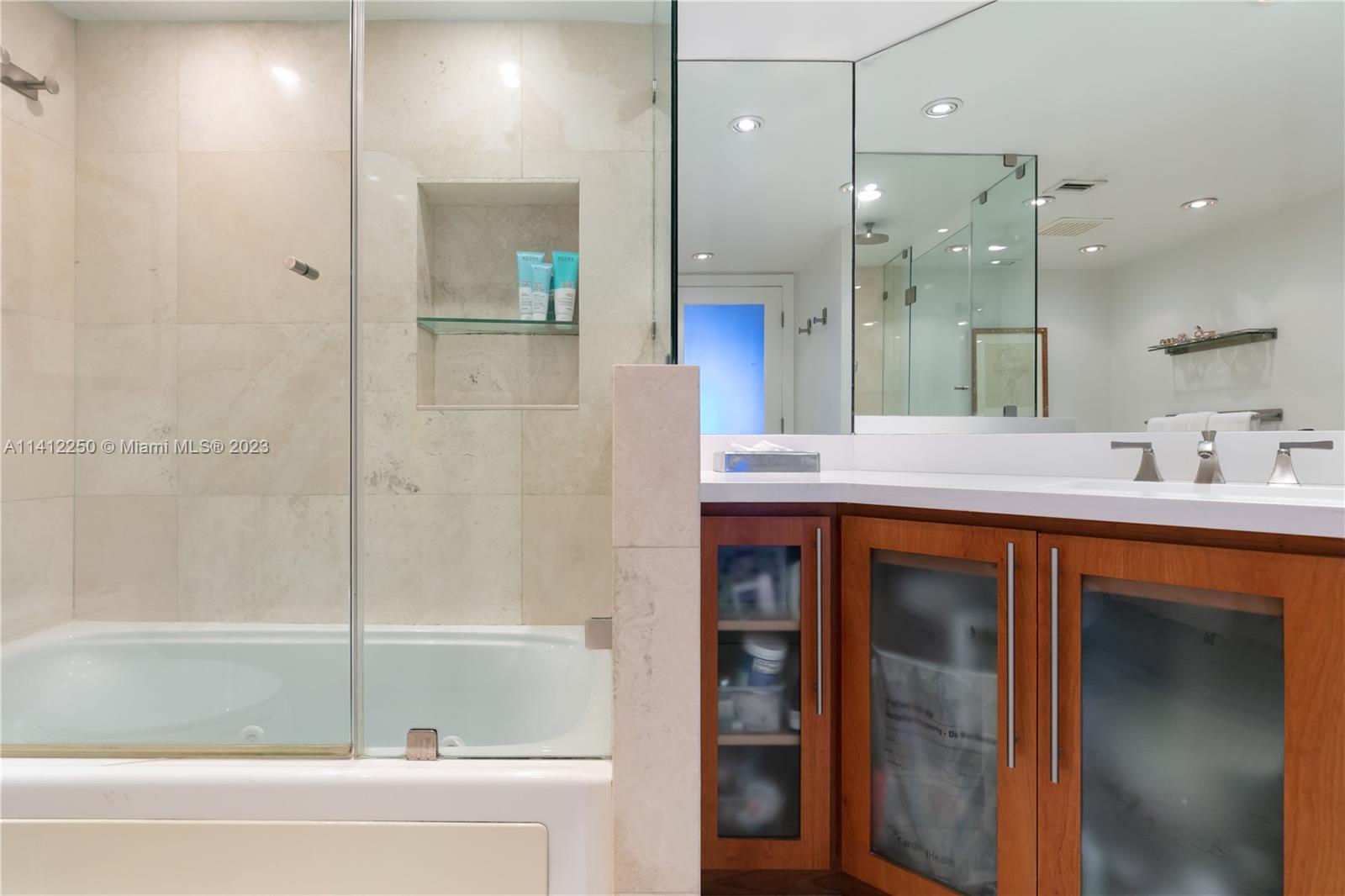 2333 Brickell Avenue, Unit 1511 Miami, FL 33129 - Photo 28 of 59 a bathroom with a tub sink shower and mirror