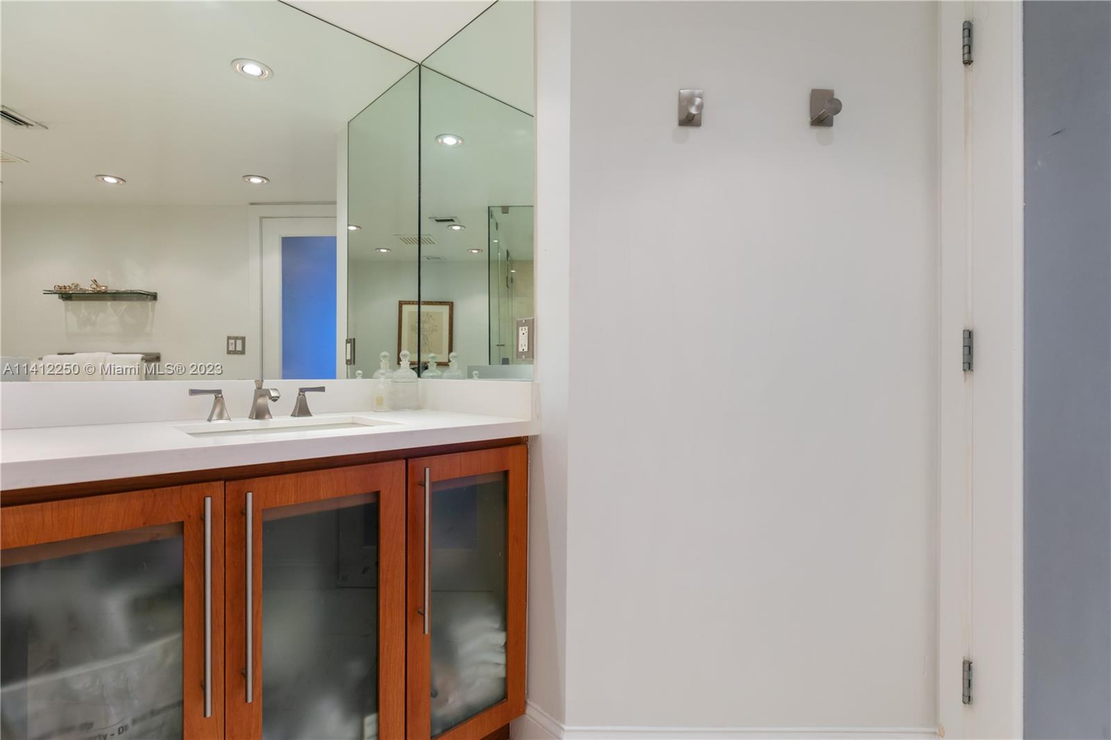 2333 Brickell Avenue, Unit 1511 Miami, FL 33129 - Photo 29 of 59 a bathroom with a sink and a mirror