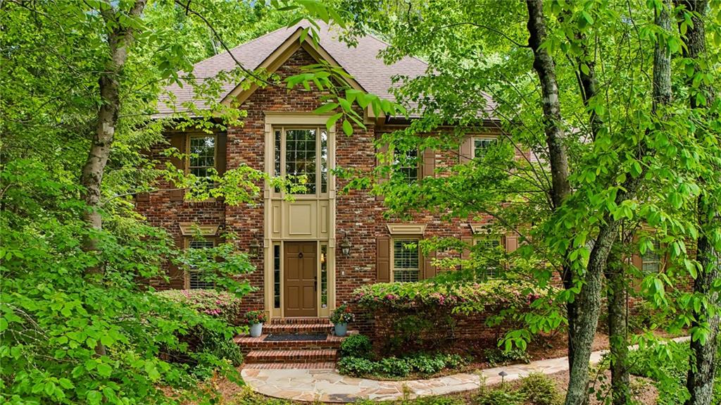 145 Wing Mill Road Atlanta, GA 30350 - Photo 1 of 69 a front view of a house with a yard and potted plants