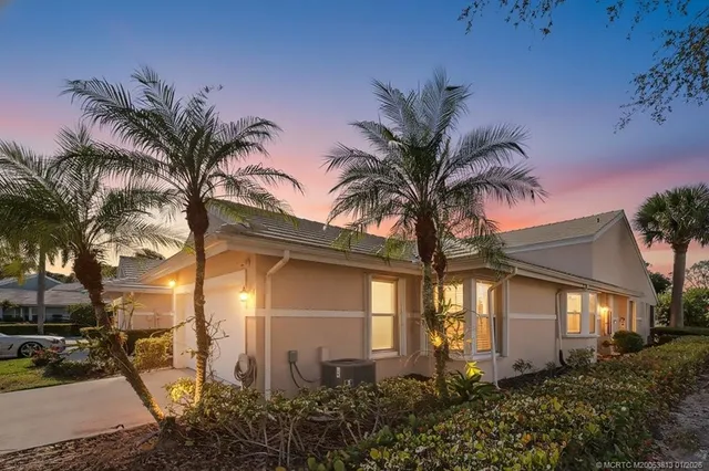 a front view of multiple houses with yard