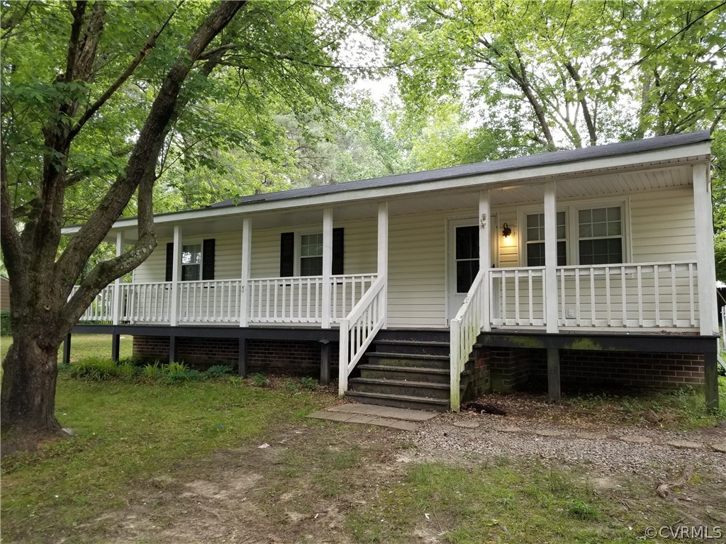 a view of a house with a backyard and stairs