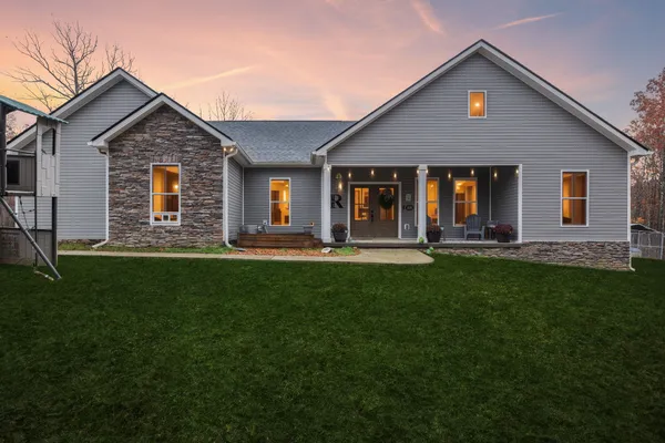 a front view of house with yard and green space