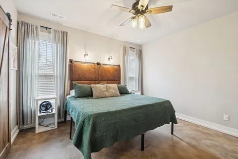 a en suite bathroom with a double vanity sink a mirror and a toilet