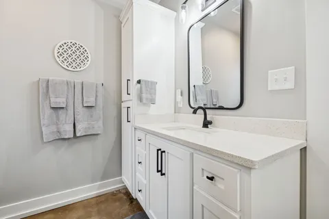a bathroom with a sink vanity and a mirror