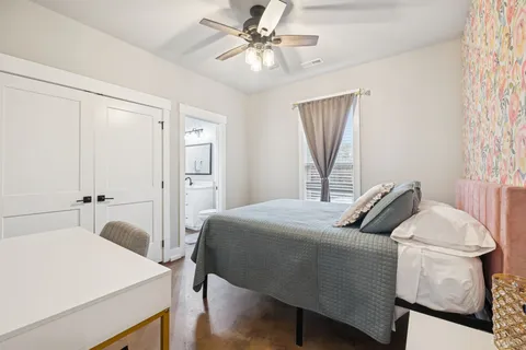 a bedroom with a bed a window and couch