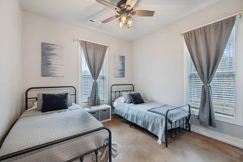 a bed room with a bed and a chandelier