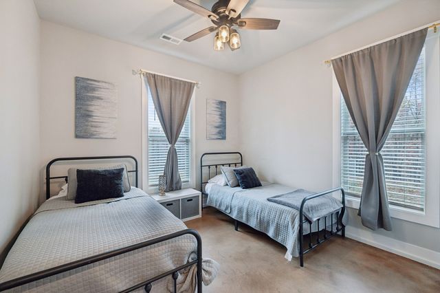 a bed room with a bed and a chandelier