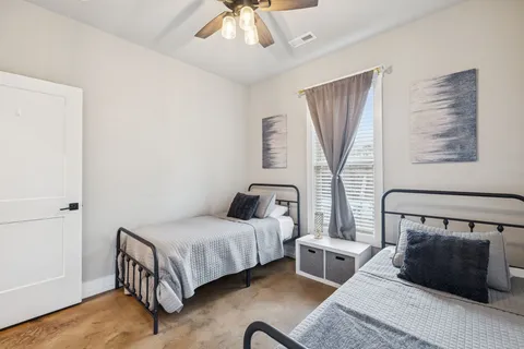 a bedroom with a bed a window and couch