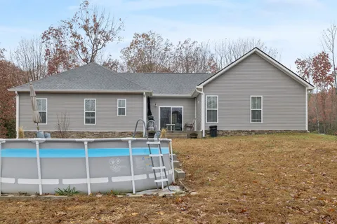 a view of a house with a yard and wooden fence