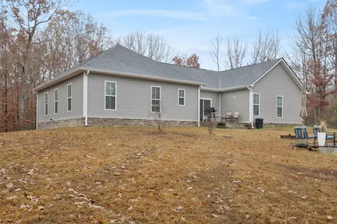 a view of a house with a yard and garage