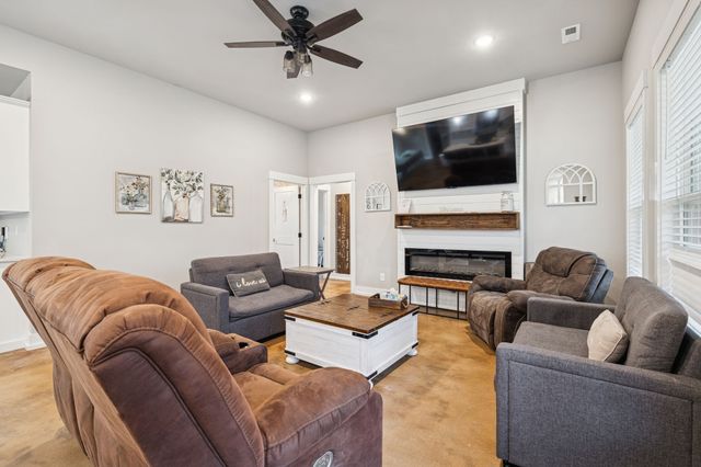 a living room with furniture fireplace and flat screen tv