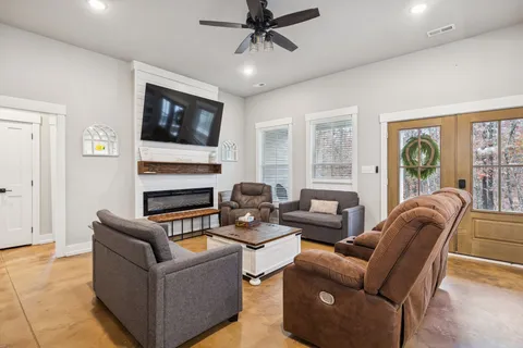 a living room with furniture a flat screen tv and a fireplace