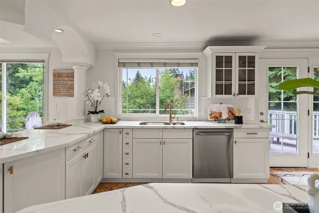 a kitchen with a sink and large window