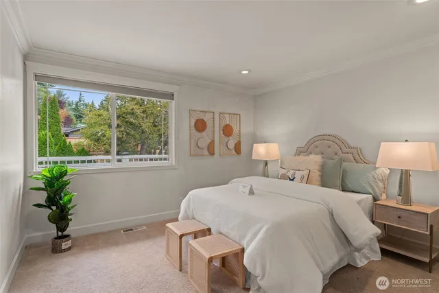 a bedroom with a bed and a potted plant
