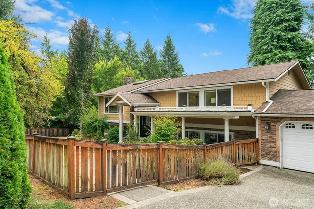 a view of a house with wooden fence