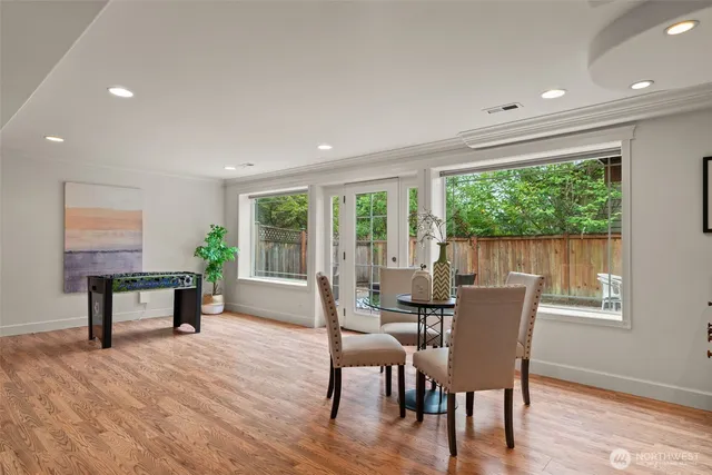 a dining room with furniture window outside view and wooden floor