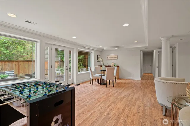 a dining room with furniture and wooden floor