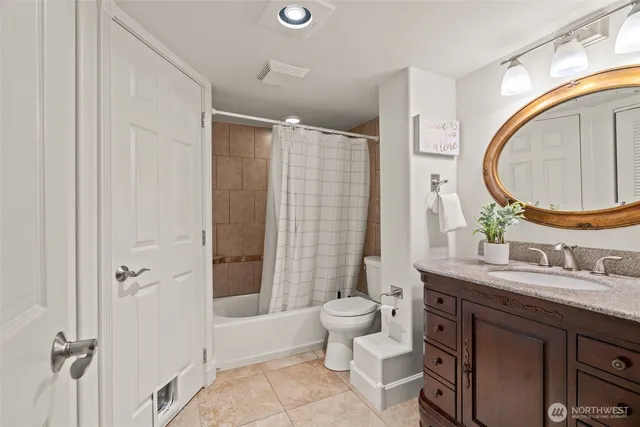 a bathroom with a double vanity sink toilet mirror and shower