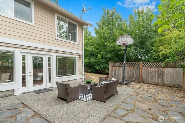 a view of a house with backyard and sitting area