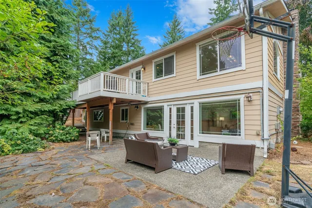 a view of a patio with couches table and chairs and potted plants