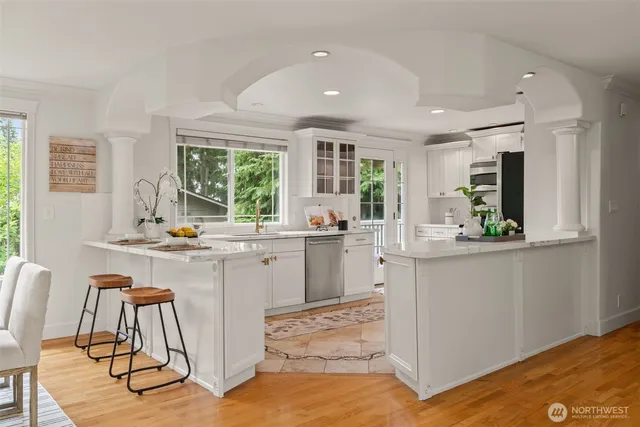 a kitchen with sink cabinets and wooden floor