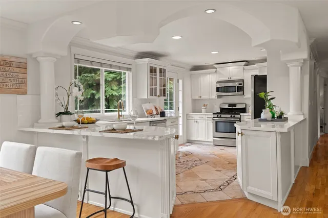 a kitchen with sink refrigerator and microwave