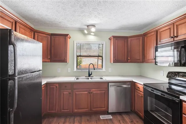 a kitchen with a sink stainless steel appliances and cabinets