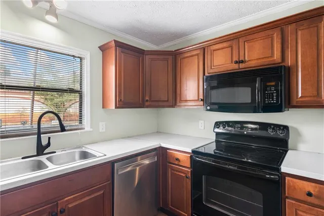 a kitchen with a sink stove top oven and microwave