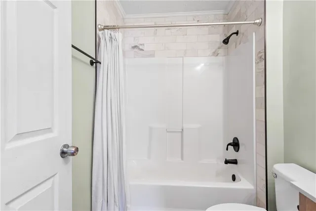a bathroom with a shower and a bath tub