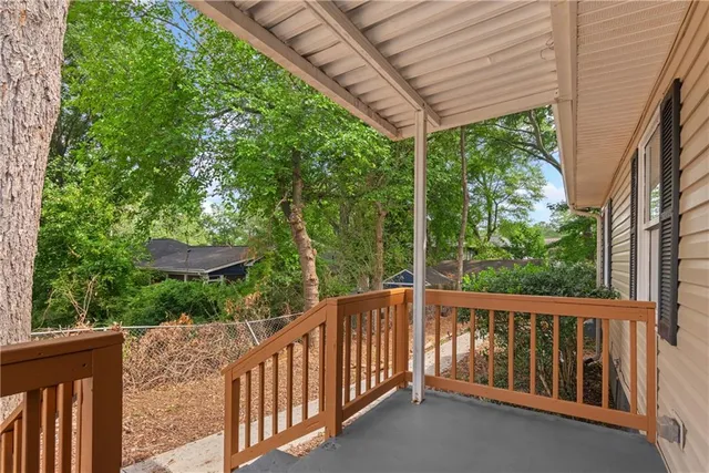 a view of a wooden deck next to a yard
