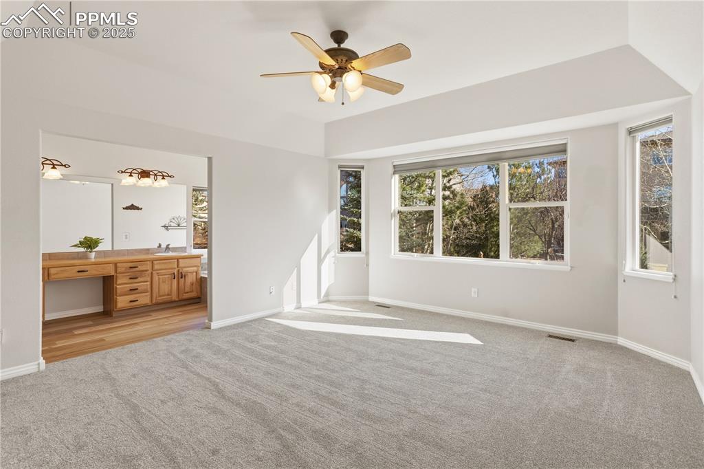 16243 Kitchener Way Monument, CO 80132 - Photo 12 of 33 a view of empty room with a fireplace and a large window